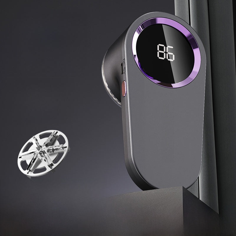A modern dark gray smart home device with a circular digital display showing '86' and a purple accent ring, shown alongside a small silver circular accessory on a dark studio background.