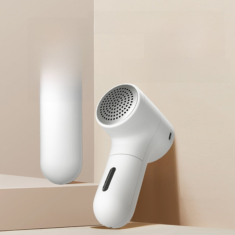 White handheld device with a cylindrical design on a beige background