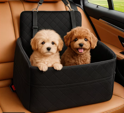 Two puppies in a black pet seat cover inside a car.